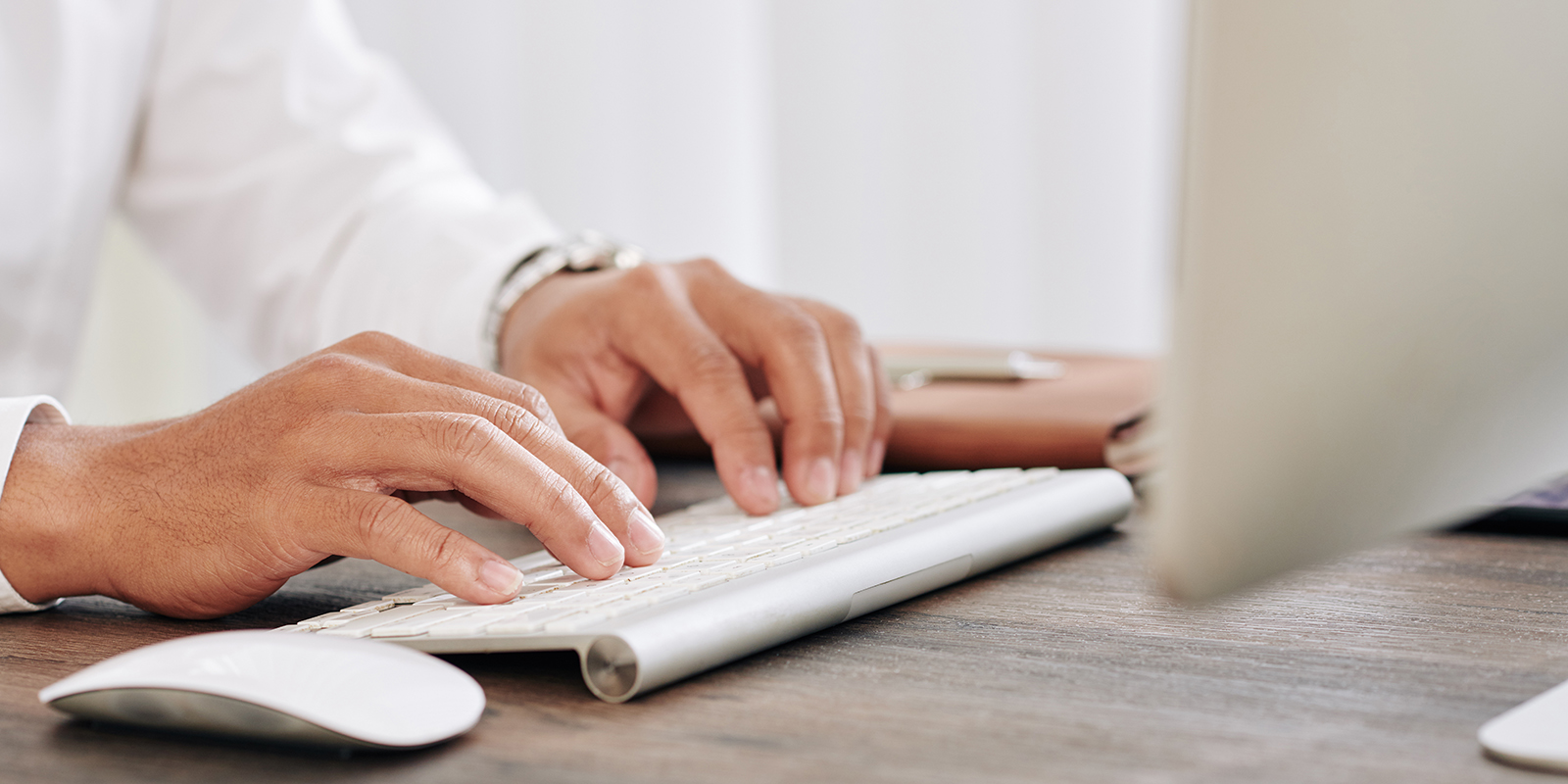 Close-up image of entrepreneur typing on keyboard when creating report for financial department