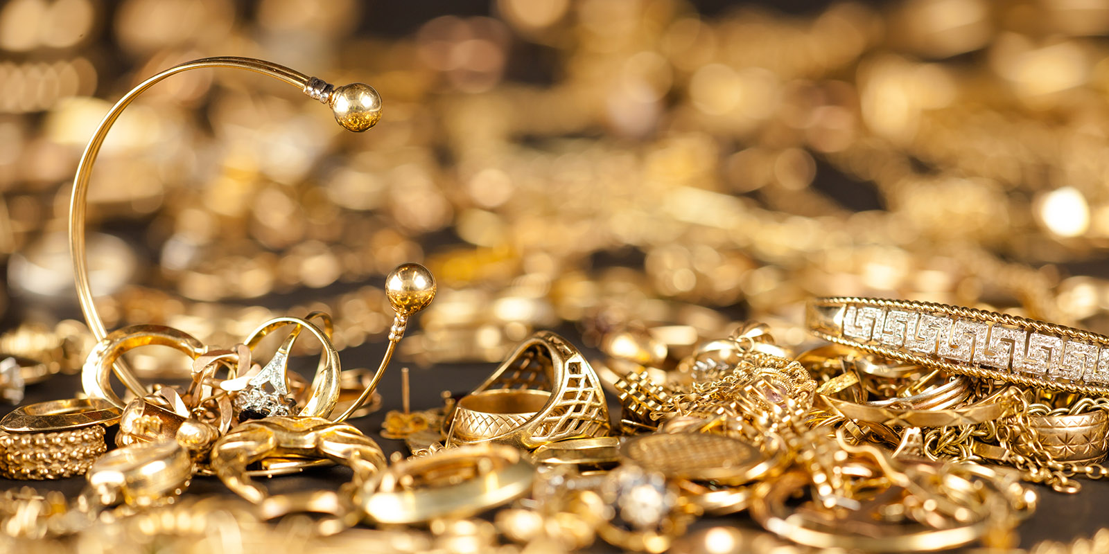 Table of scrap gold being inspected