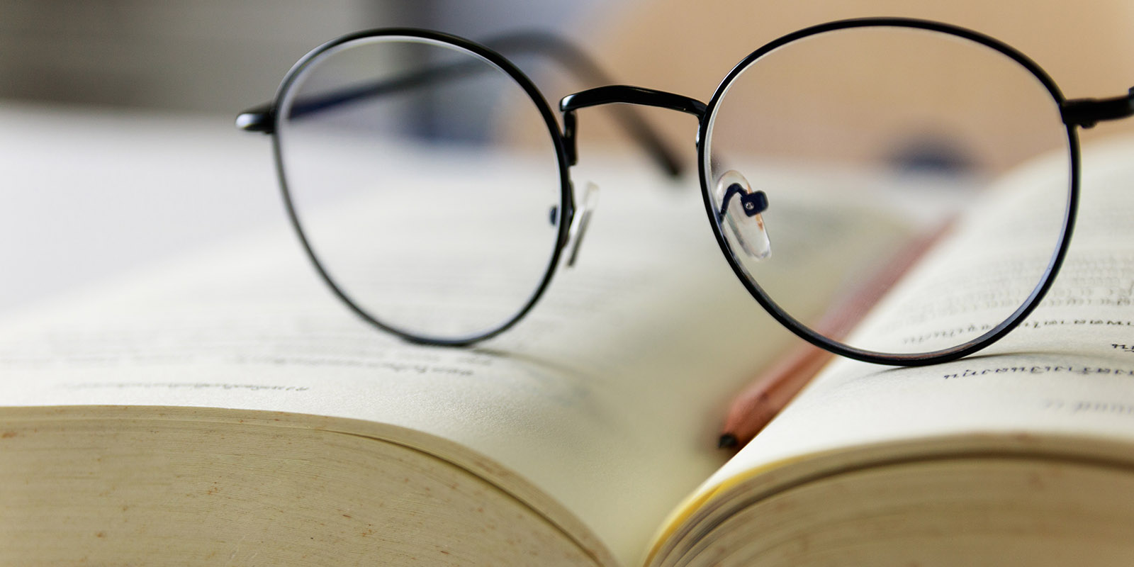 Reading glasses placed on open books