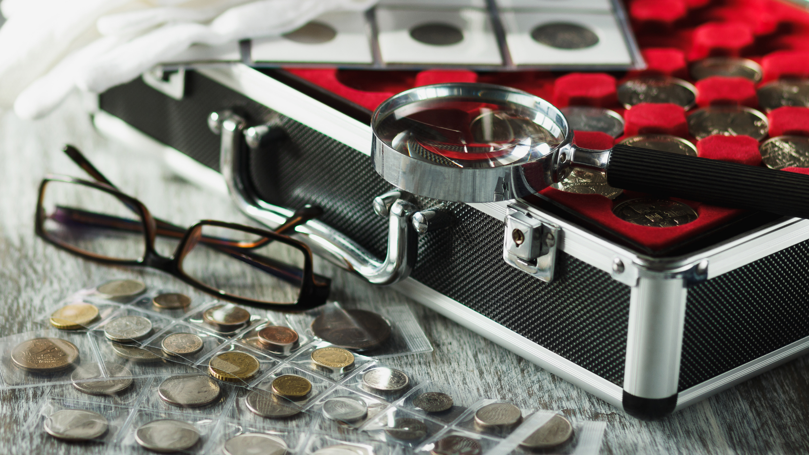 Collector Coins in a case with a magnifying glass